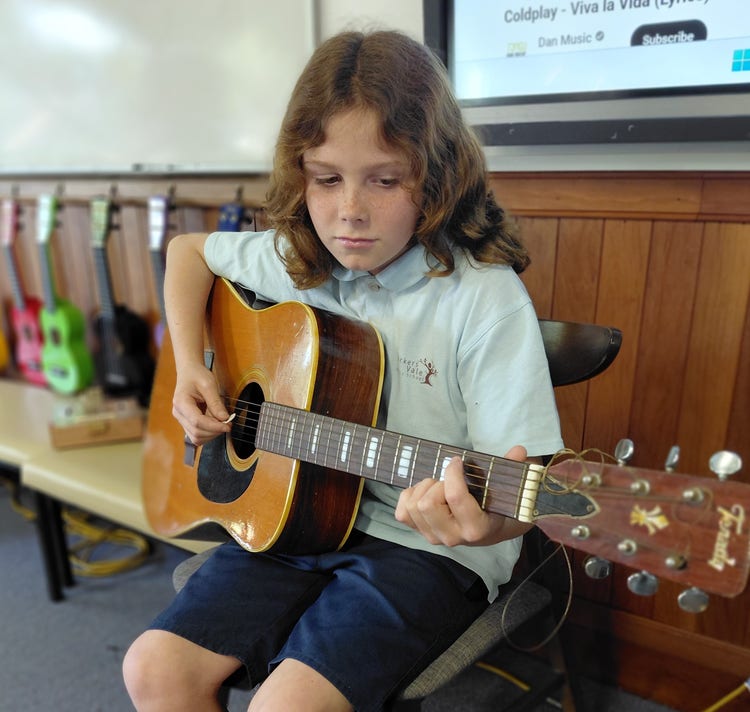 Student playing guitar